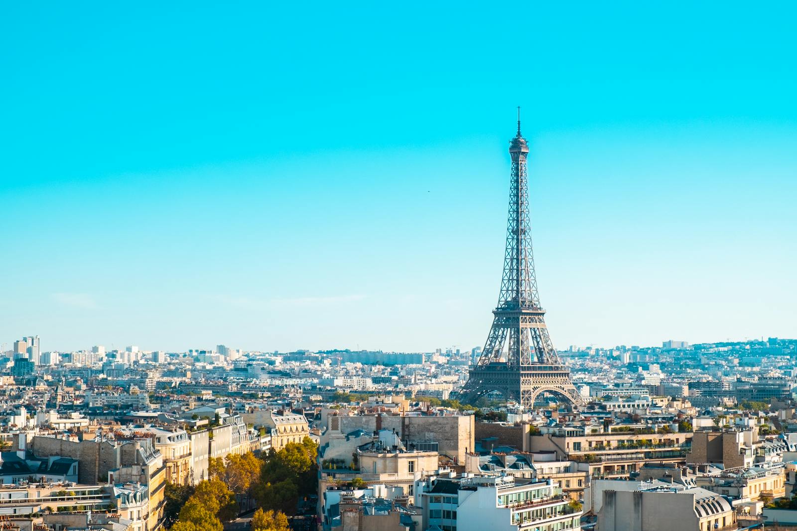 Eiffel Tower standing tall over the Paris cityscape under a clear blue sky
