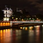 Paris night scene with Eiffel Tower and river reflections