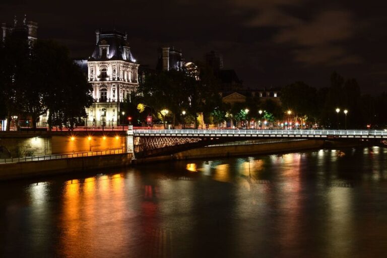 Paris night scene with Eiffel Tower and river reflections