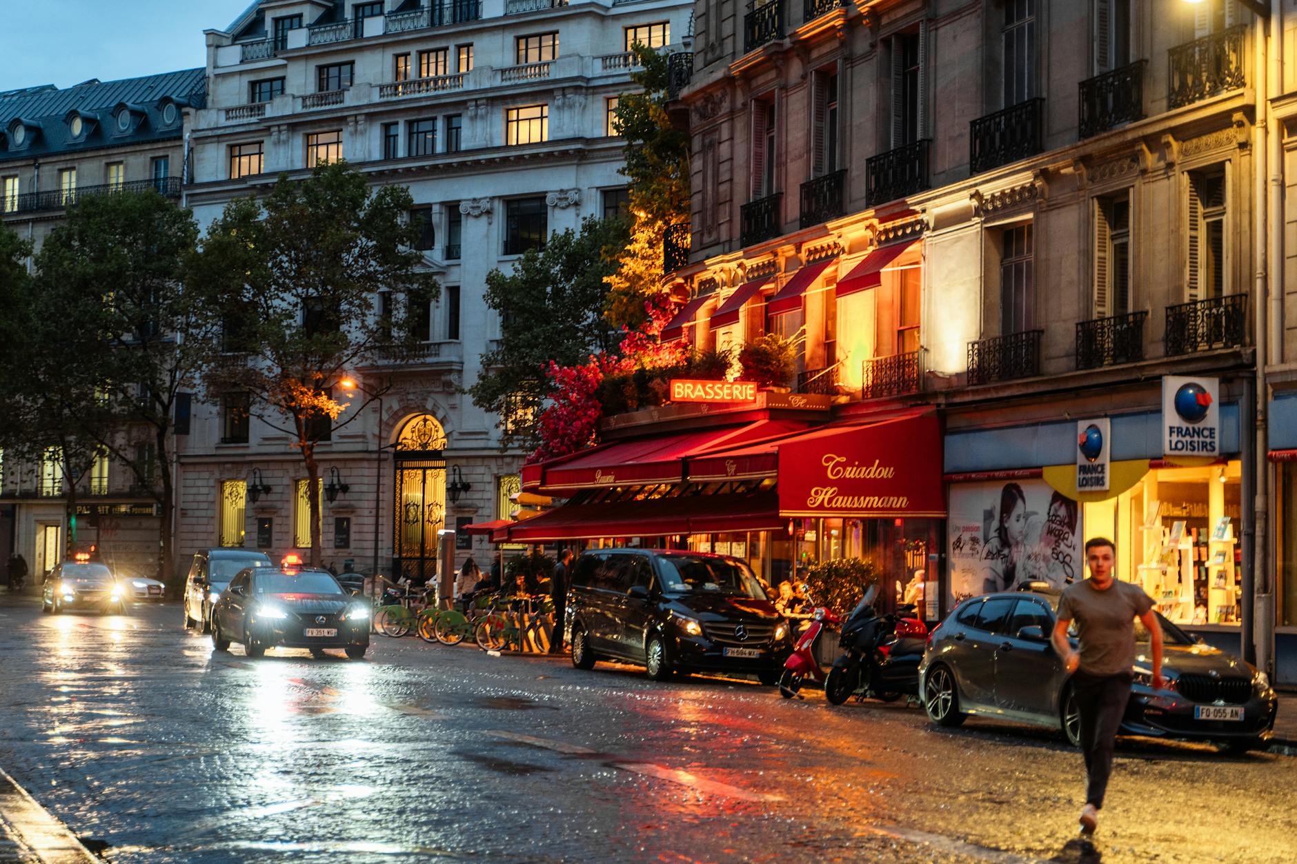 Paris nightlife with illuminated brasserie and wet streets