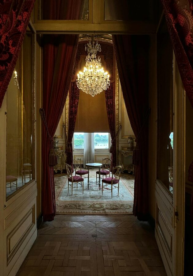 Luxurious interior of a Parisian palace salon with chandeliers and drapes