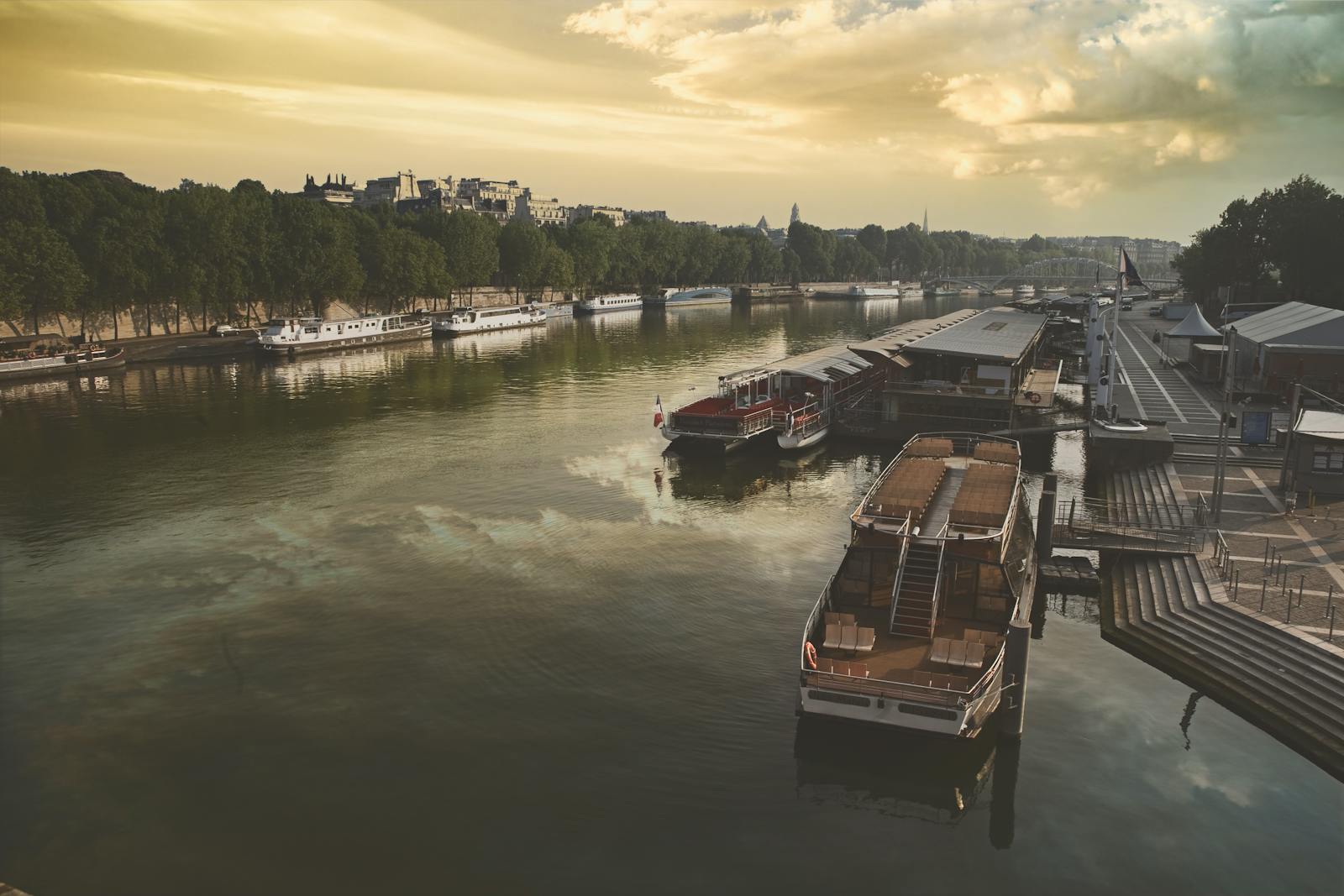 Paris Seine River boats docked at sunset along the quay