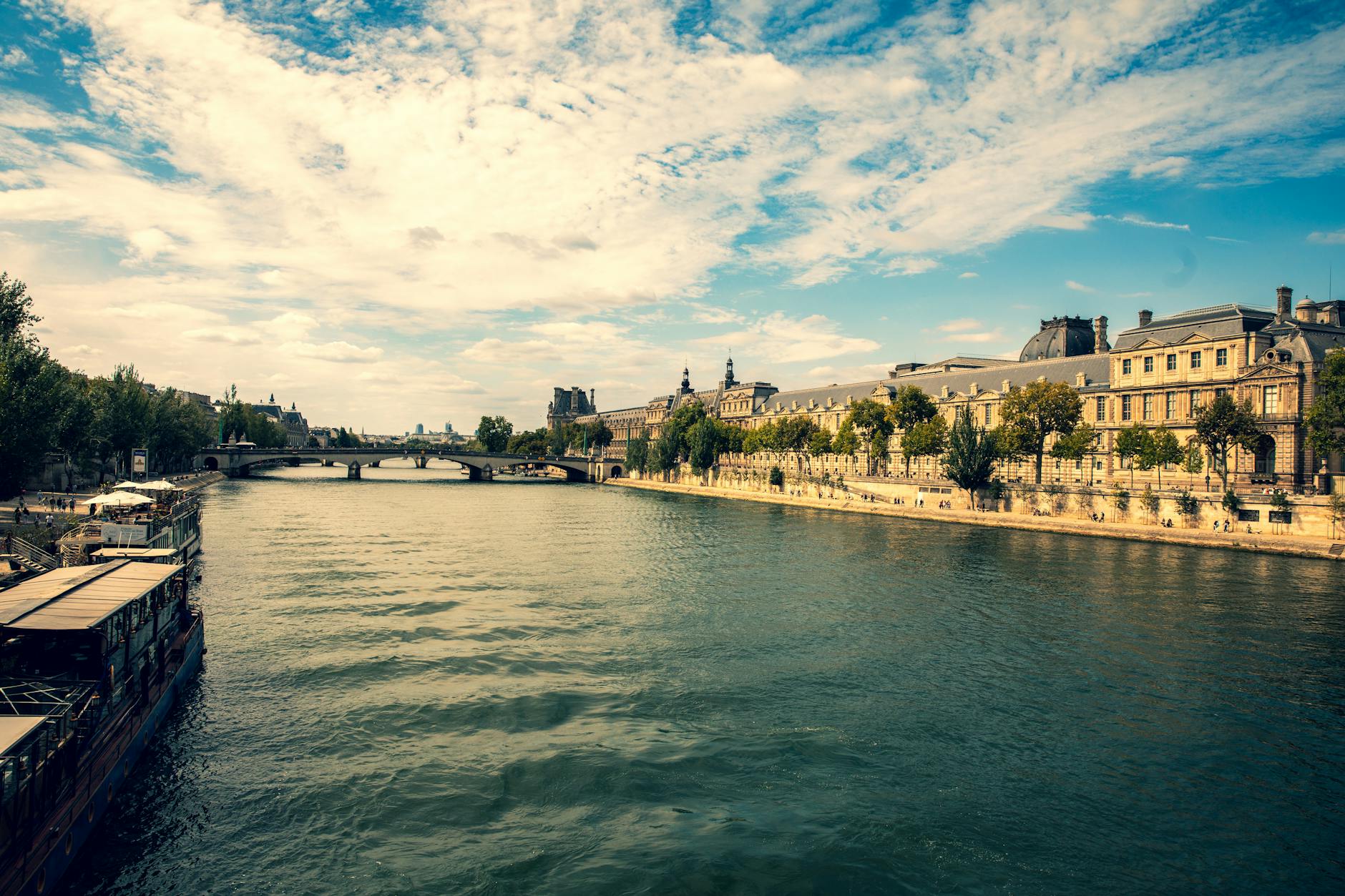 A serene view of Paris along the Seine with historic architecture