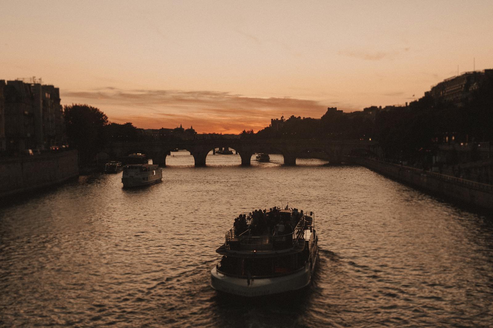 Sunset view during a Paris Seine River cruise with golden light on the water