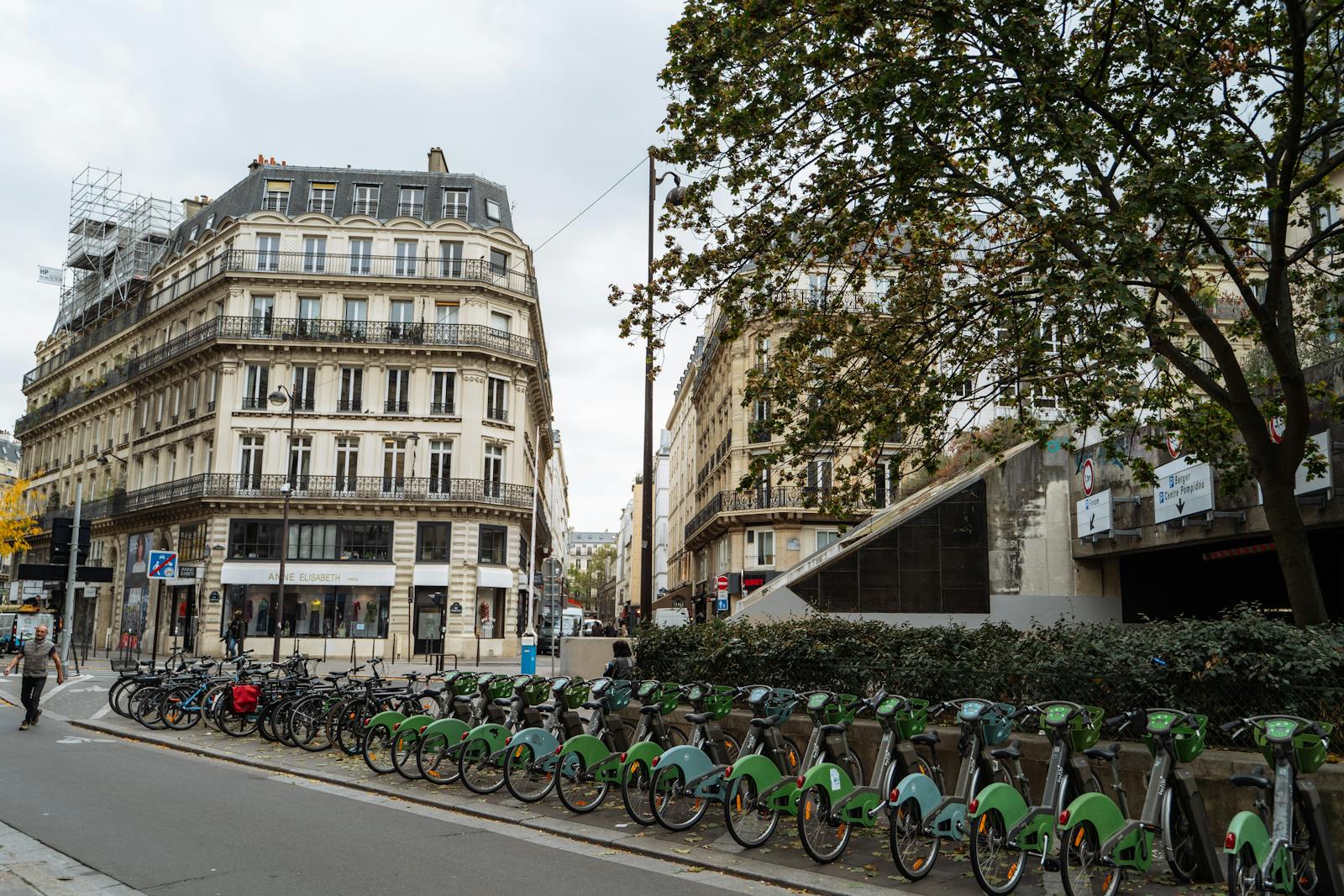 Bike rentals on a Paris street with classic French architecture in the background