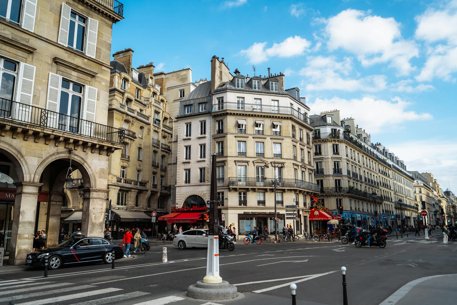 Classical Paris street with Haussmann architecture under a clear blue sky