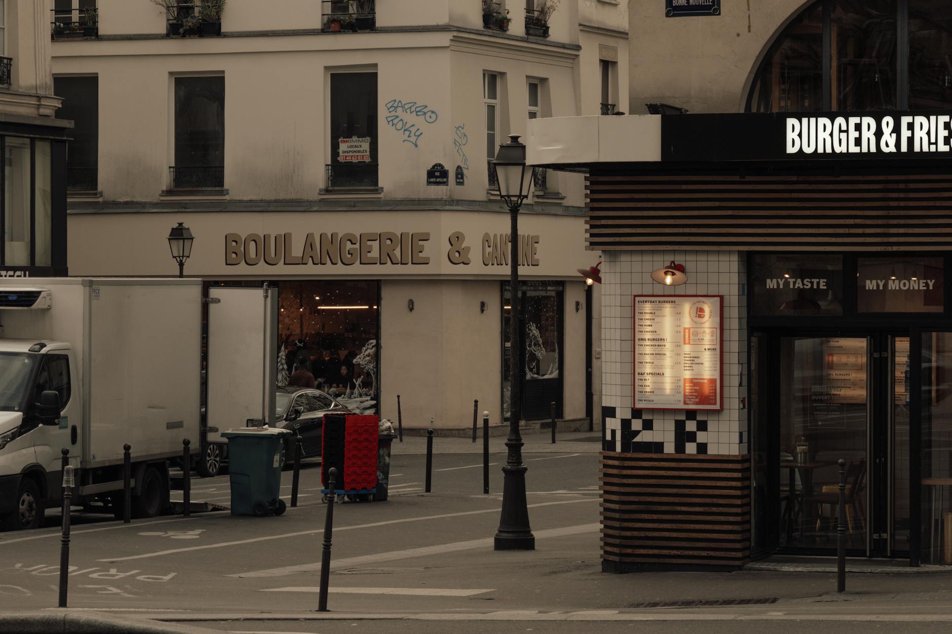 Paris street corner boulangerie in the evening with warm window light