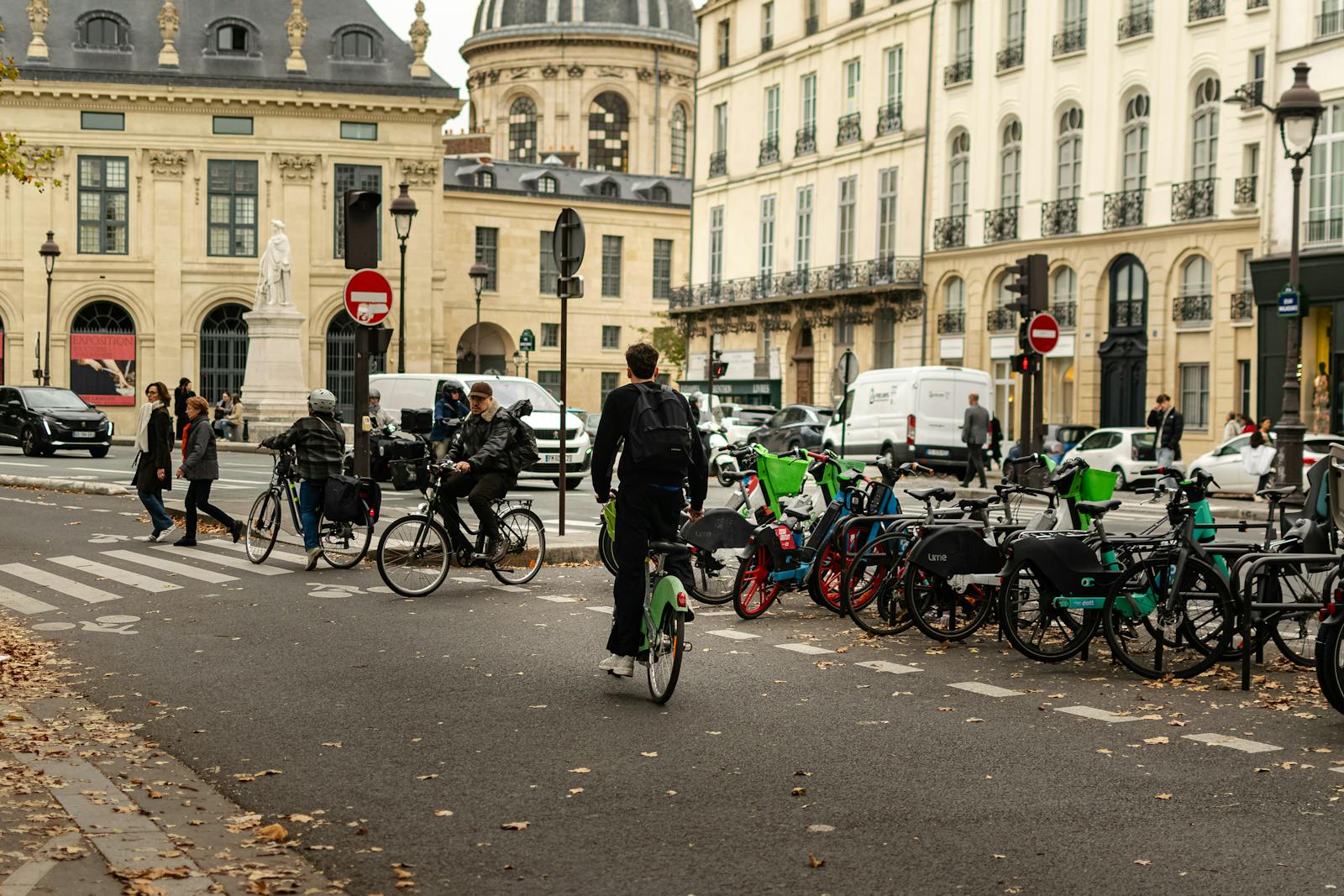 A typical Paris street scene with cyclists, pedestrians, and historic French architecture