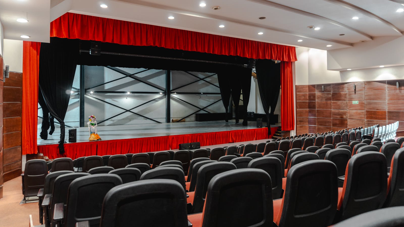 Parisian cabaret theater with red curtains and stage ready for a performance
