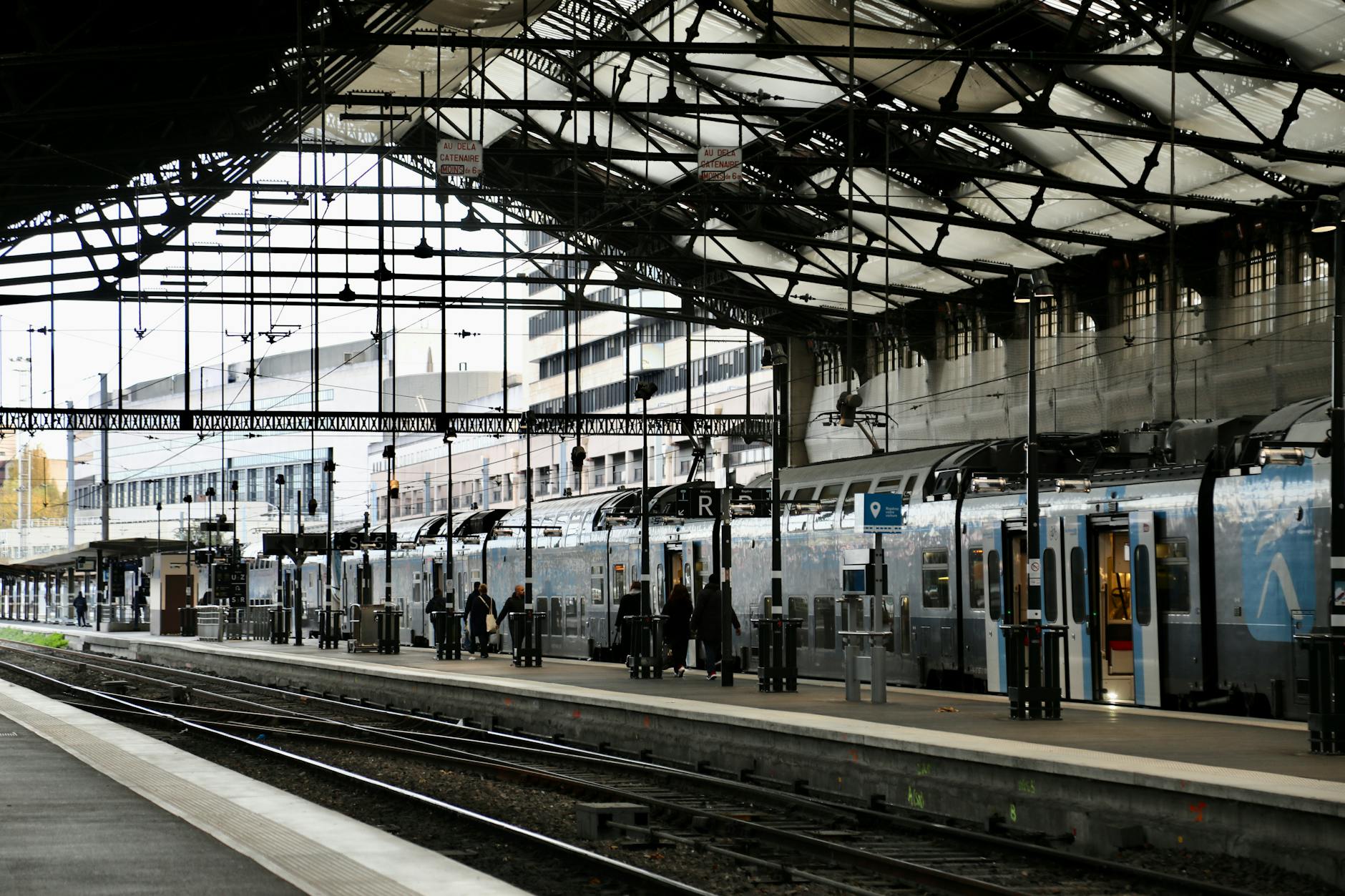 Paris train station with commuters boarding trains
