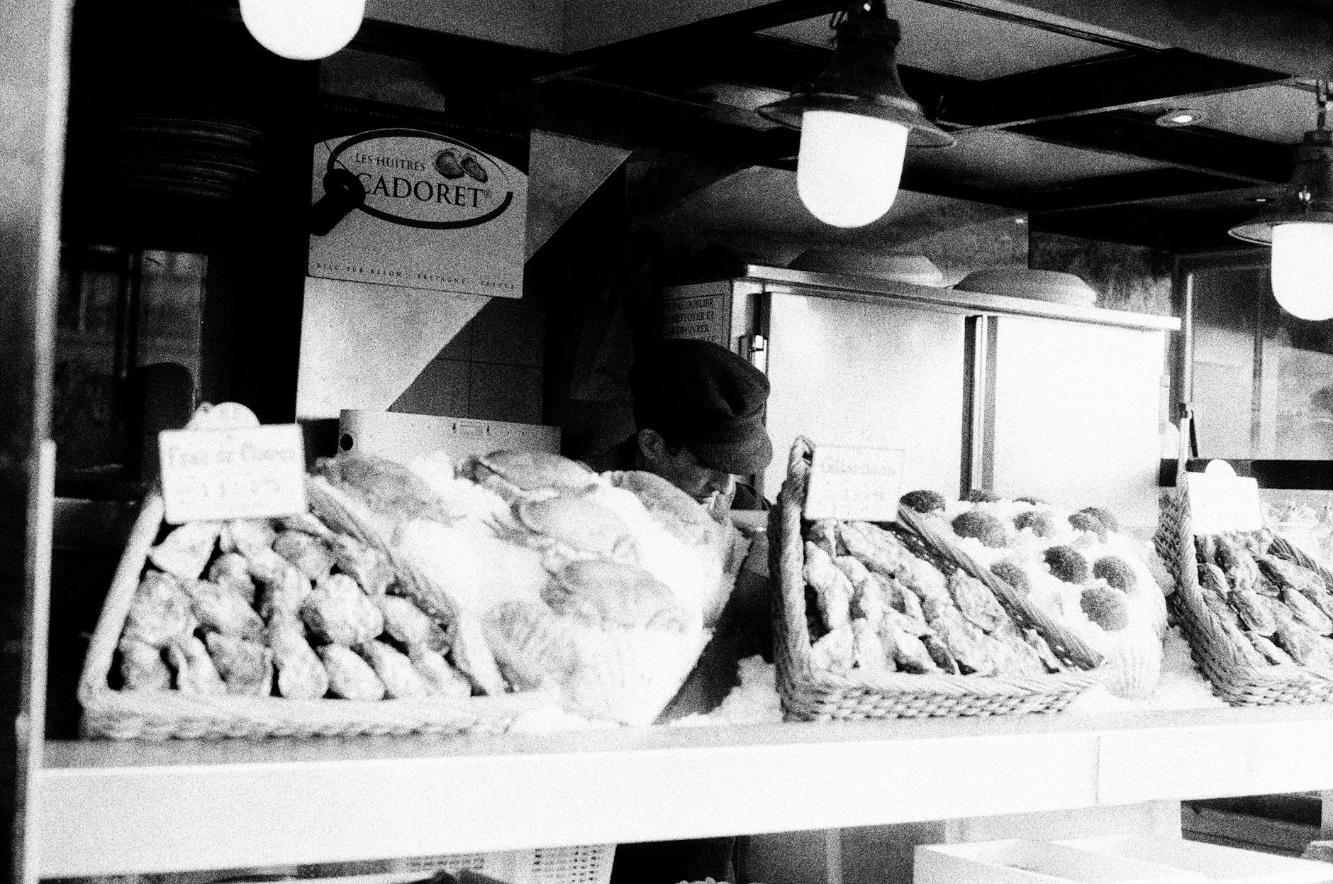 Nostalgic black and white image of a Parisian bakery stall with breads and pastries