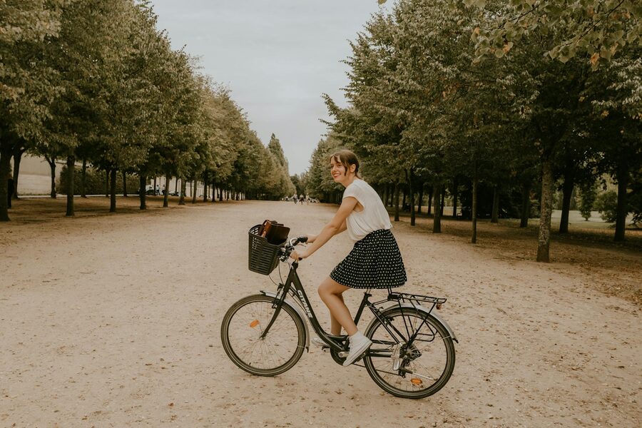 Cyclist leisurely riding through a Parisian park
