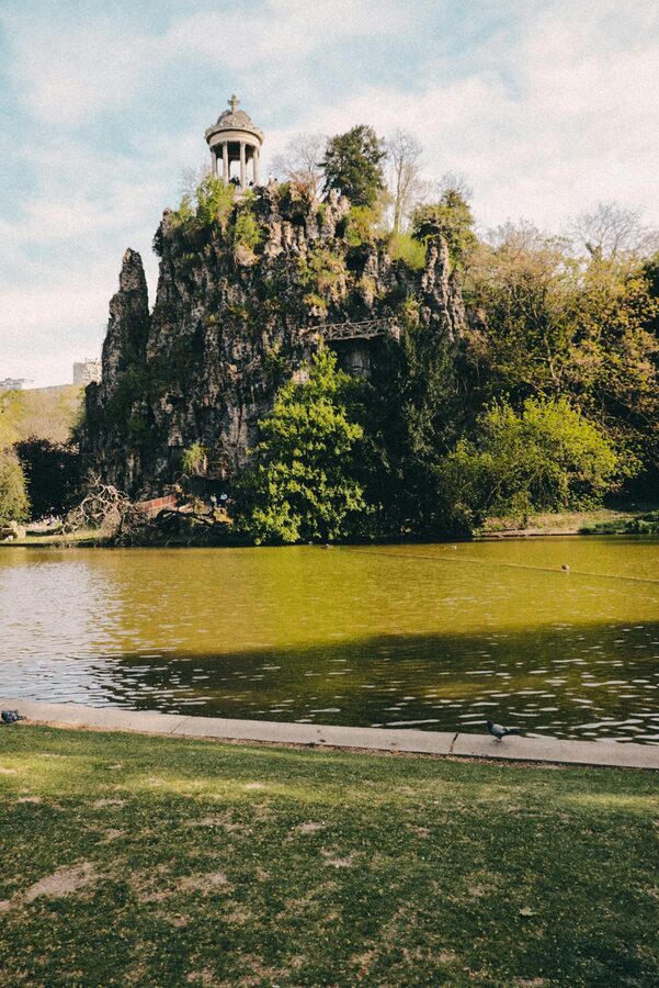 Park lake with trees in bright spring weather