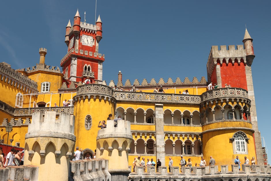 Yellow and red towers of Pena Palace against blue sky