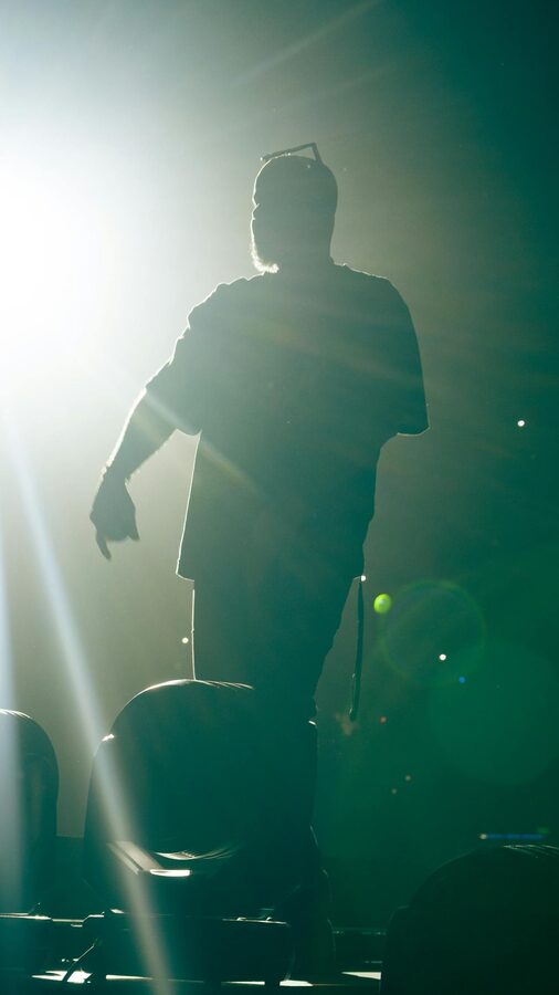 Silhouette of performer on stage in bright spotlight