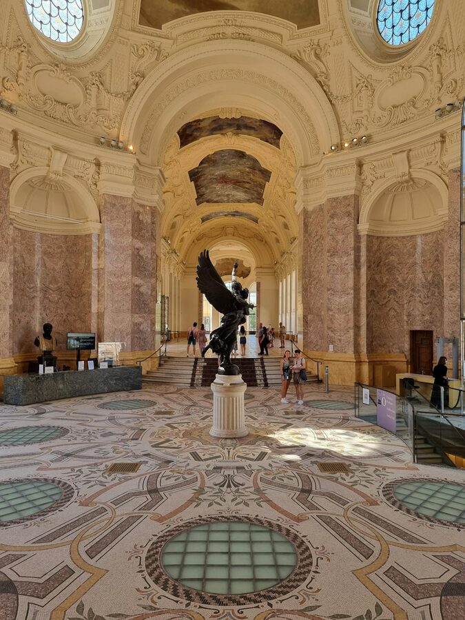 Elegant interior of Petit Palais with statue and intricate design in Paris