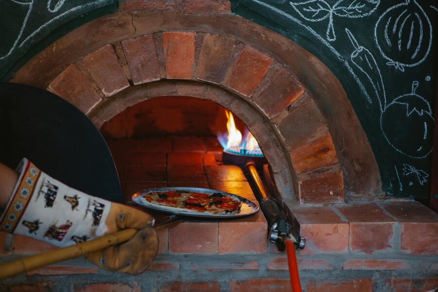 Pizza baking in a traditional brick oven