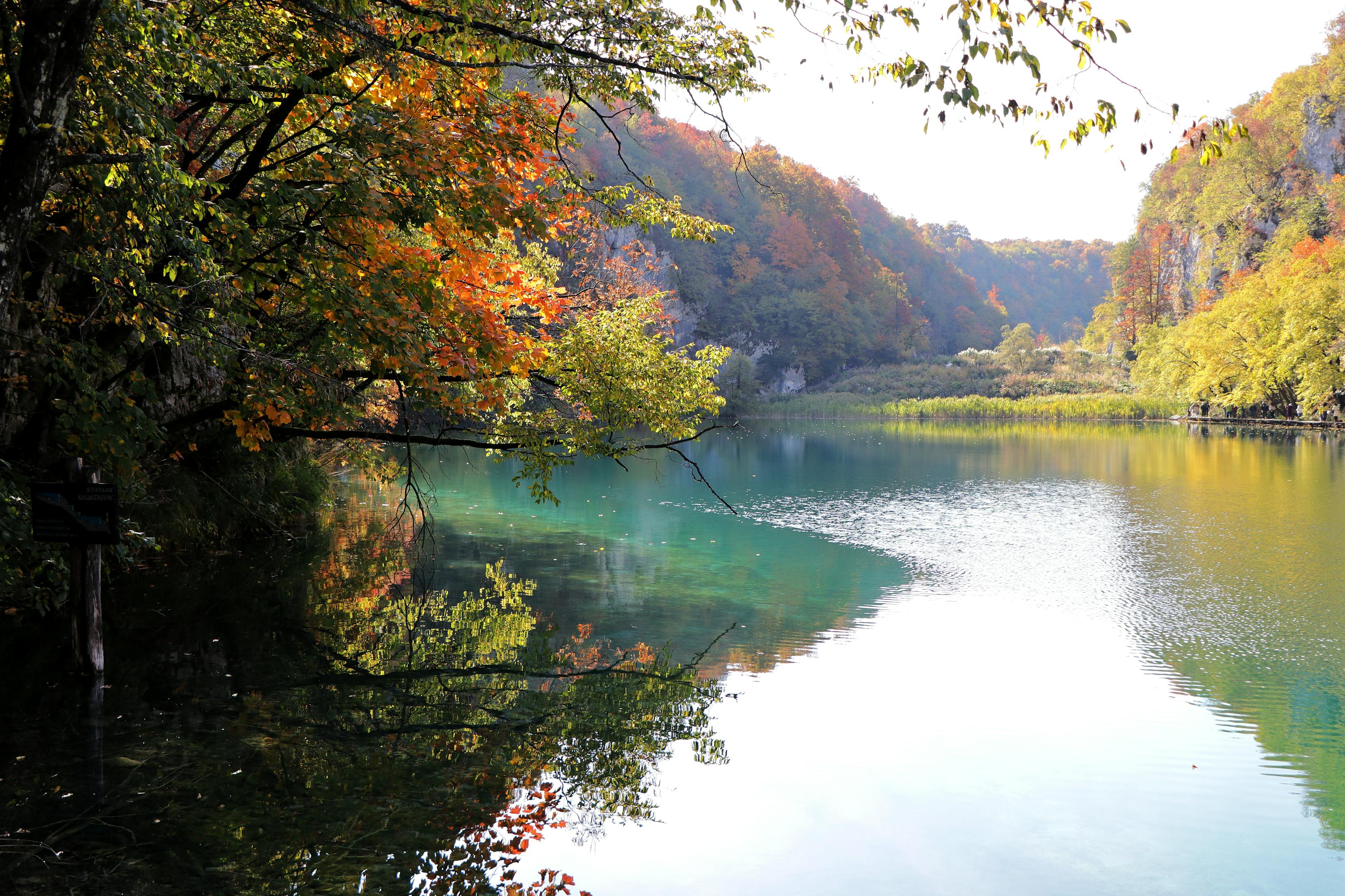 Stunning autumn scenery at Plitvice Lakes featuring vibrant foliage and tranquil waters