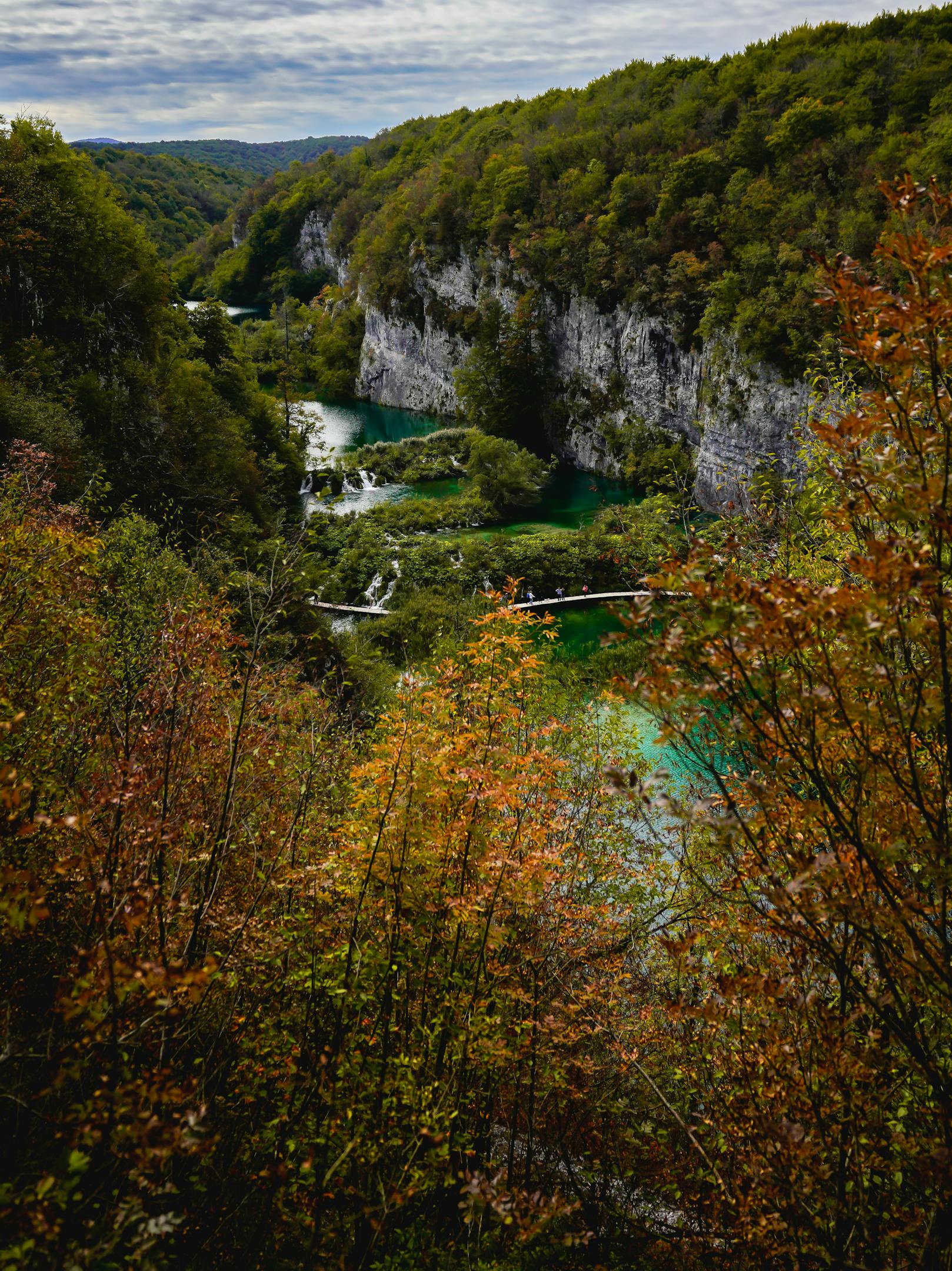Breathtaking view of Plitvice Lakes with vivid autumn foliage and turquoise waters