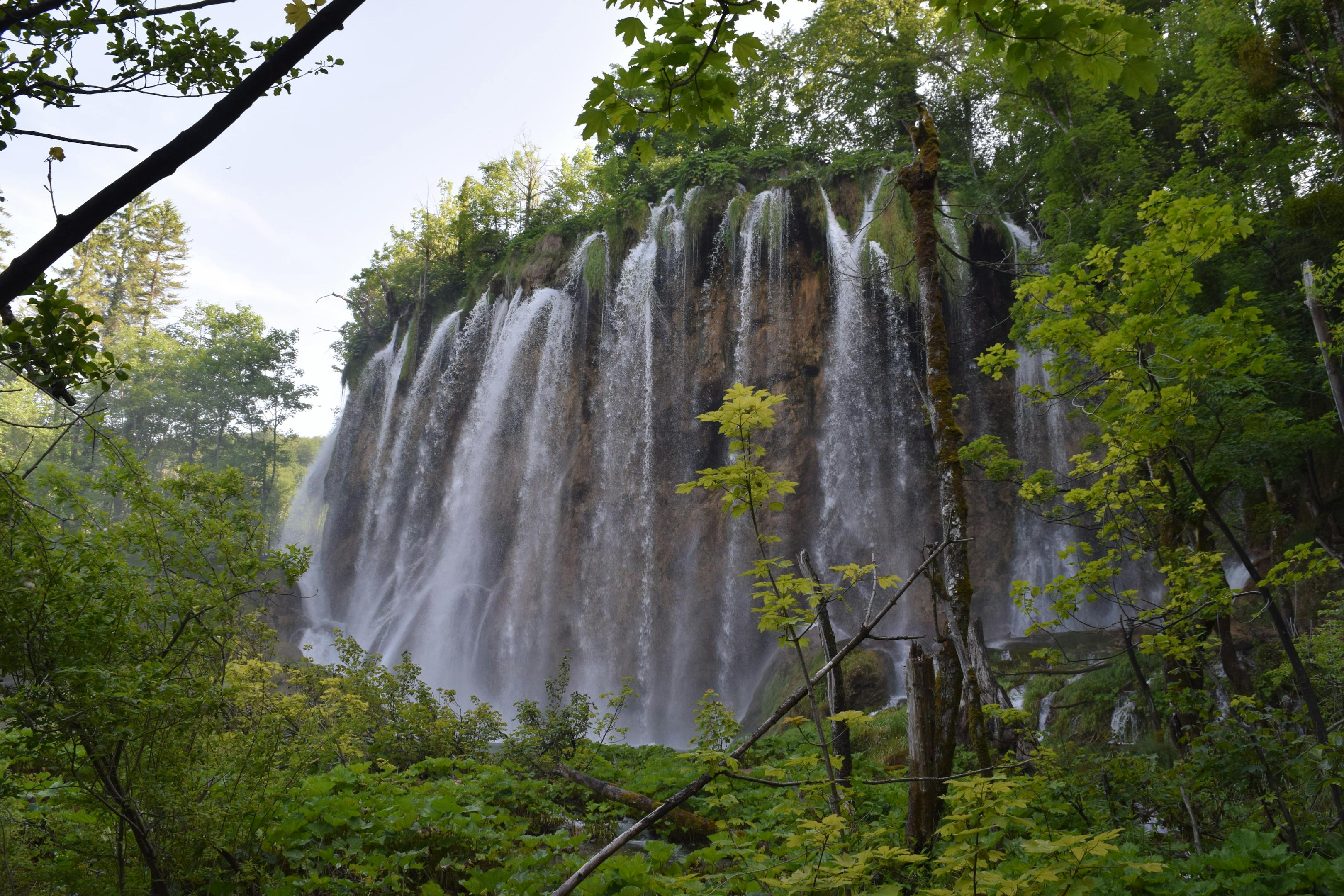 A stunning waterfall cascading through lush forest in Croatia