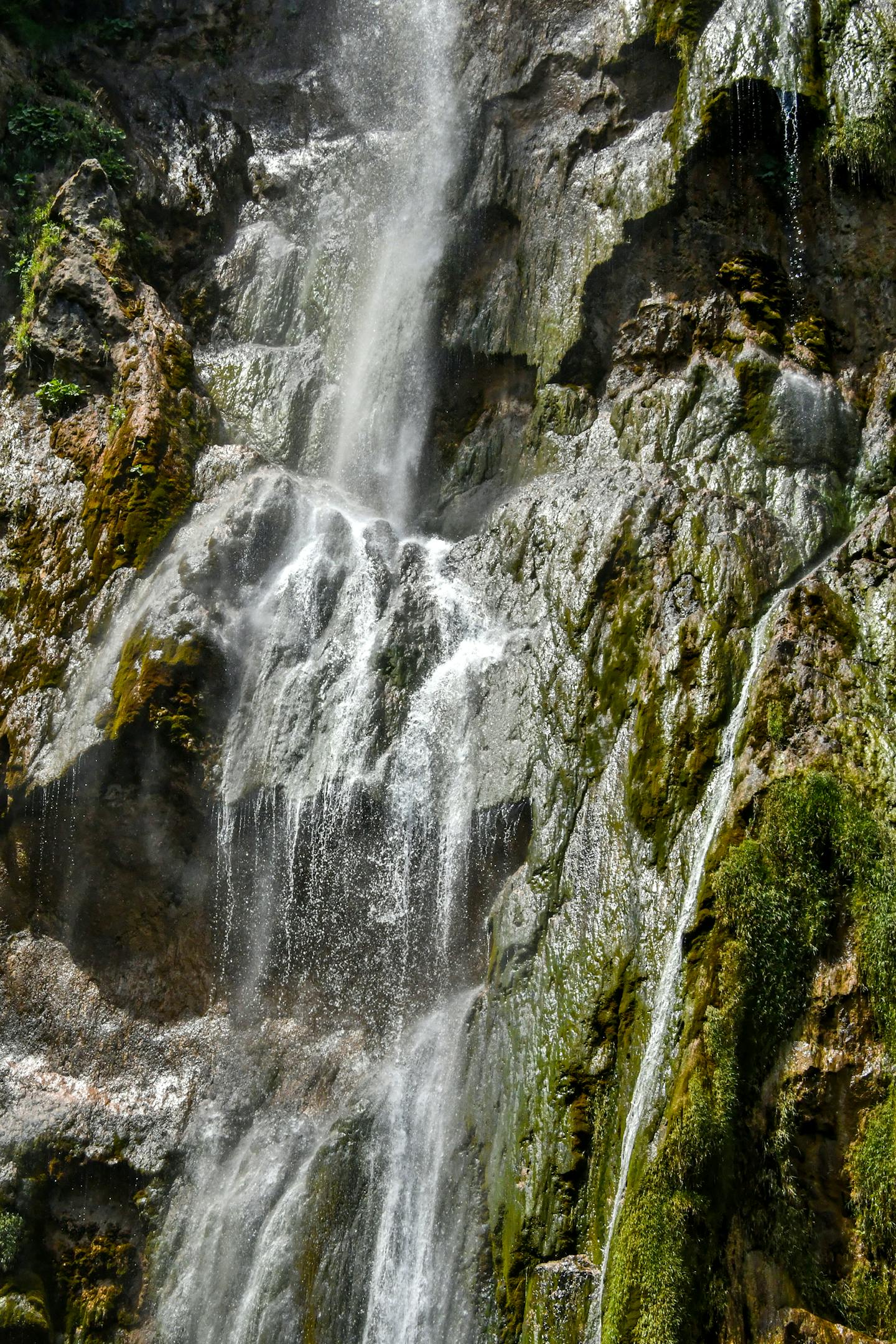 Breathtaking waterfall cascades over mossy rocks in Plitvice Lakes National Park