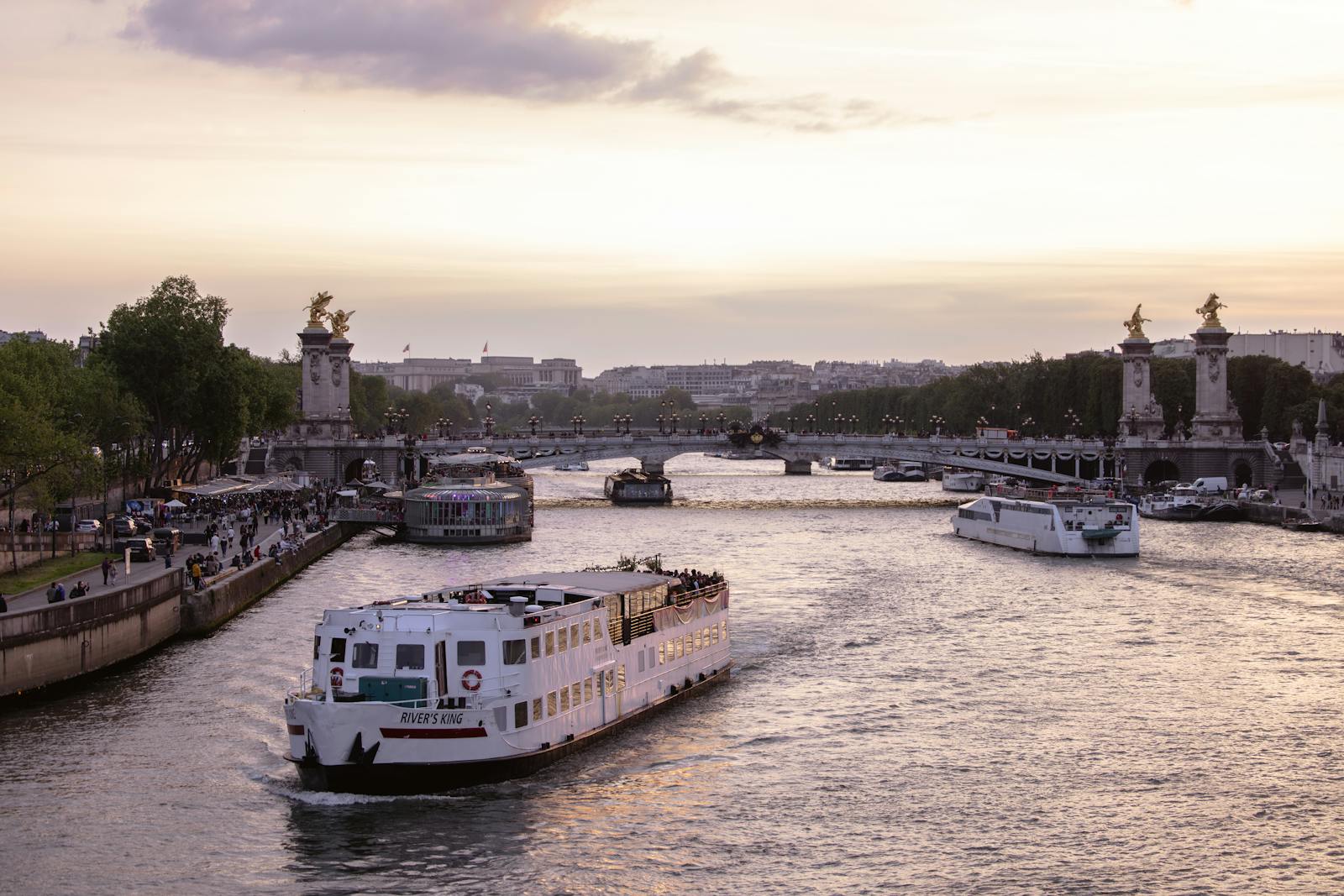Pont Alexandre III at sunset over the Seine River with Paris skyline