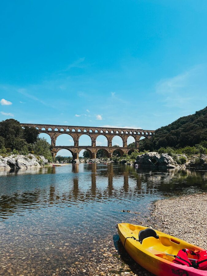 Pont du Gard with canoe on the river during daytime