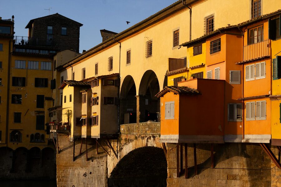 Ponte Vecchio at golden hour with colorful buildings