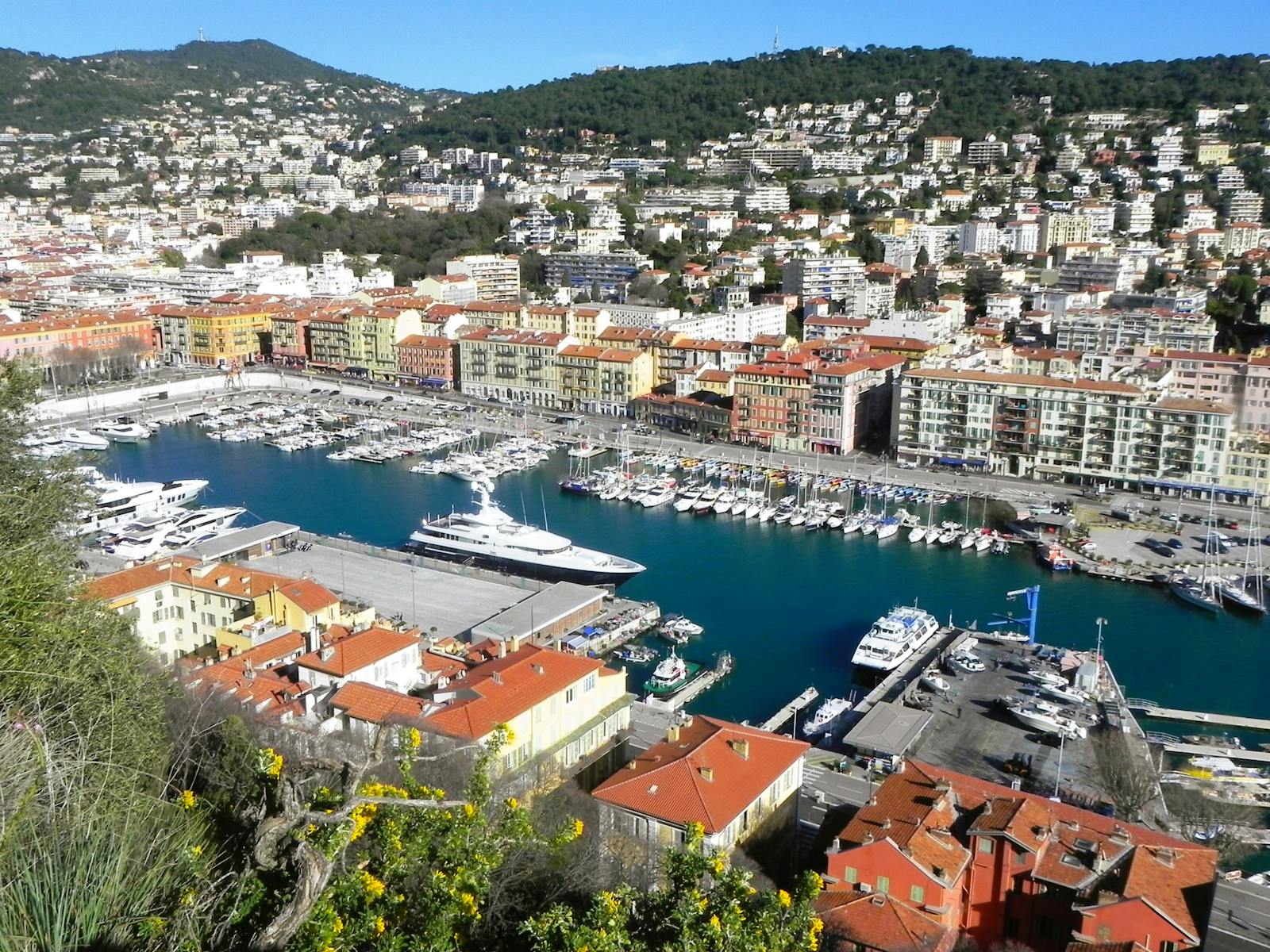 Aerial view of Port Lympia in Nice with boats and colorful harbor buildings