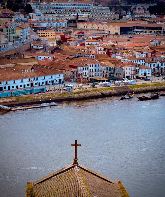 Glass of port wine in front of aging barrels