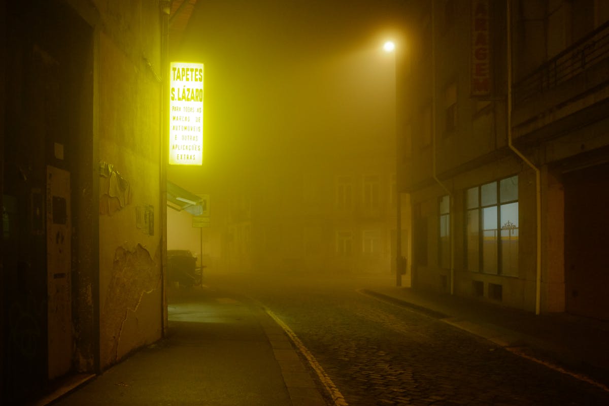 Foggy street in Porto at night with atmospheric lighting