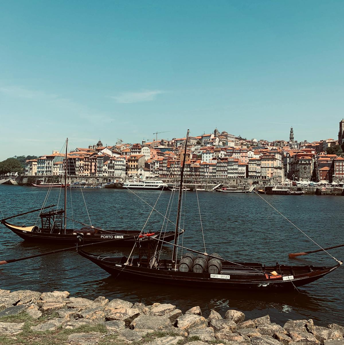 Traditional rabelo boats on the Douro River with Porto cityscape behind