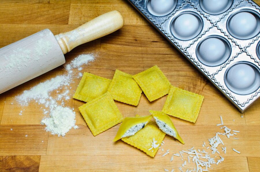 Fresh homemade ravioli with rolling pin