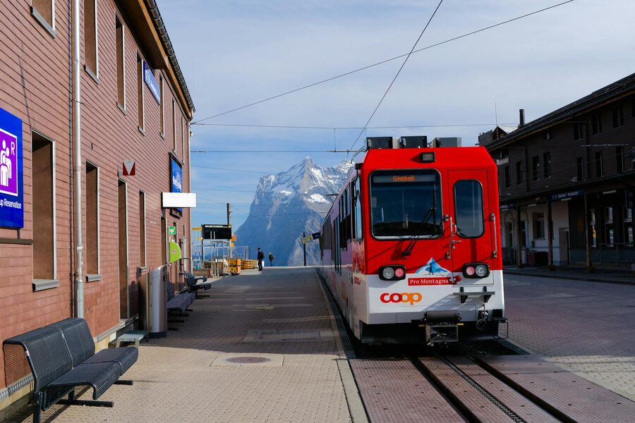 Red train at alpine mountain station