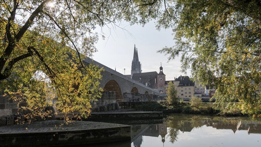 Historic stone bridge and cathedral view in Regensburg