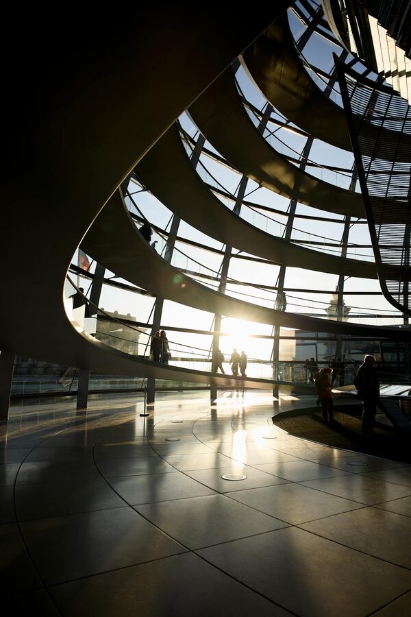 Silhouettes inside the Reichstag Dome during sunset