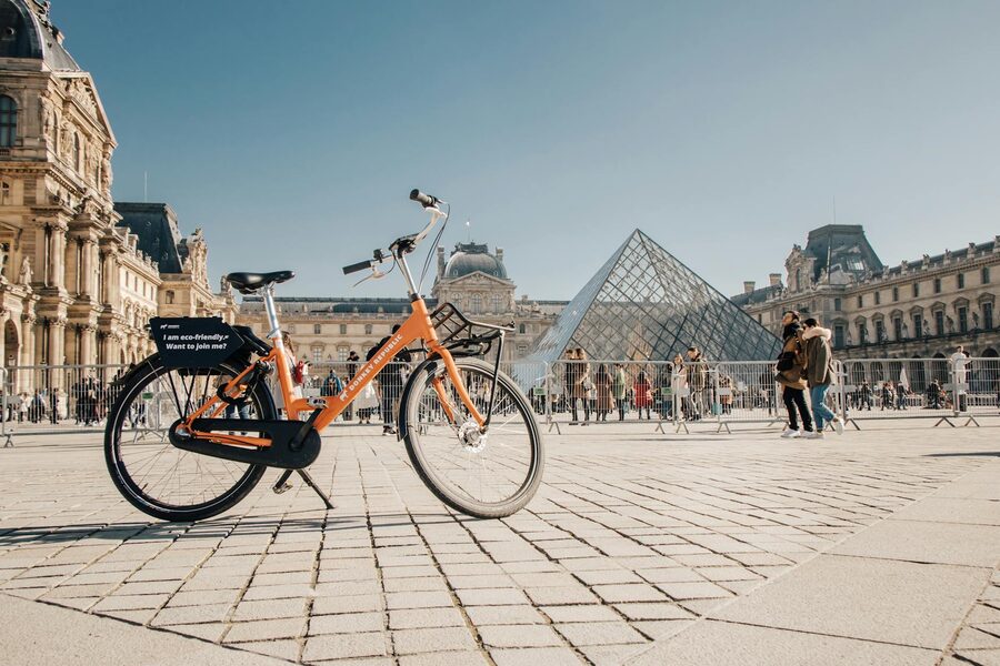 Rental bike parked near the Louvre Pyramid in Paris