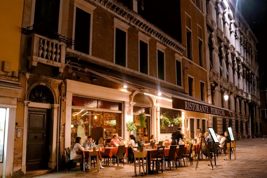 Ristorante diners enjoying evening meal in Venice