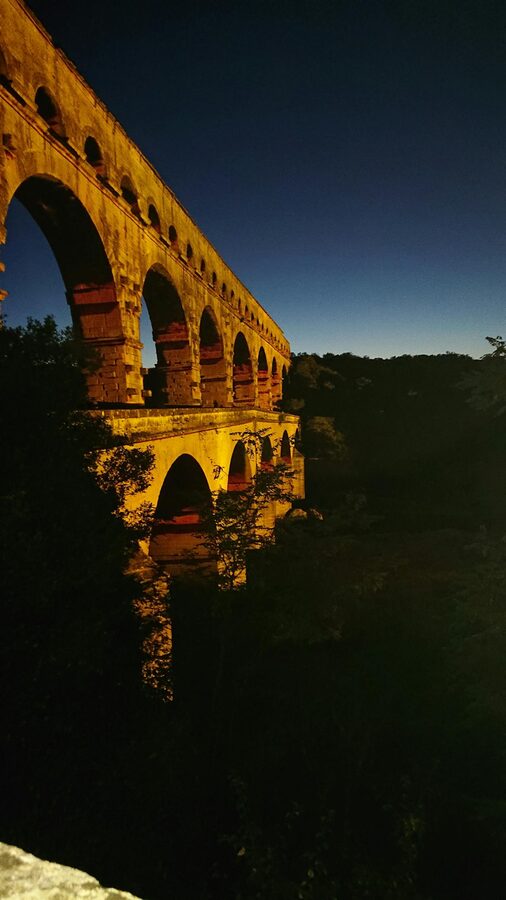 Roman aqueduct illuminated at twilight
