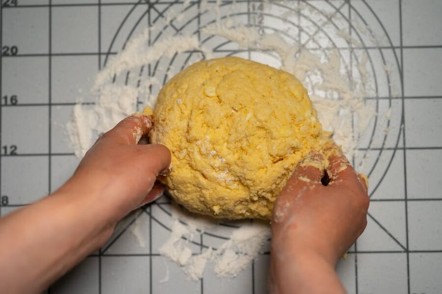 Hands kneading homemade pasta dough