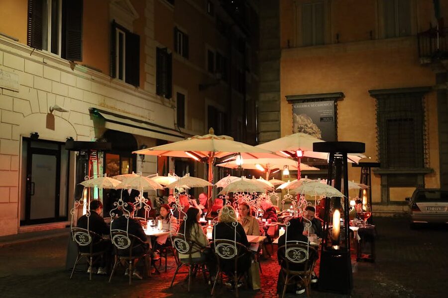 Rome outdoor dining with umbrellas at evening