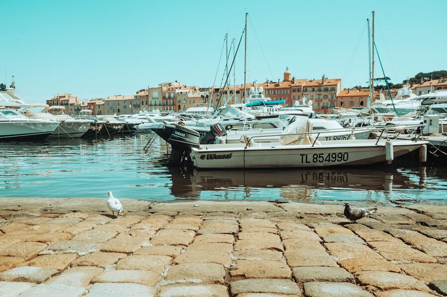 Colourful boats docked at Saint-Tropez harbor with clear summer sky