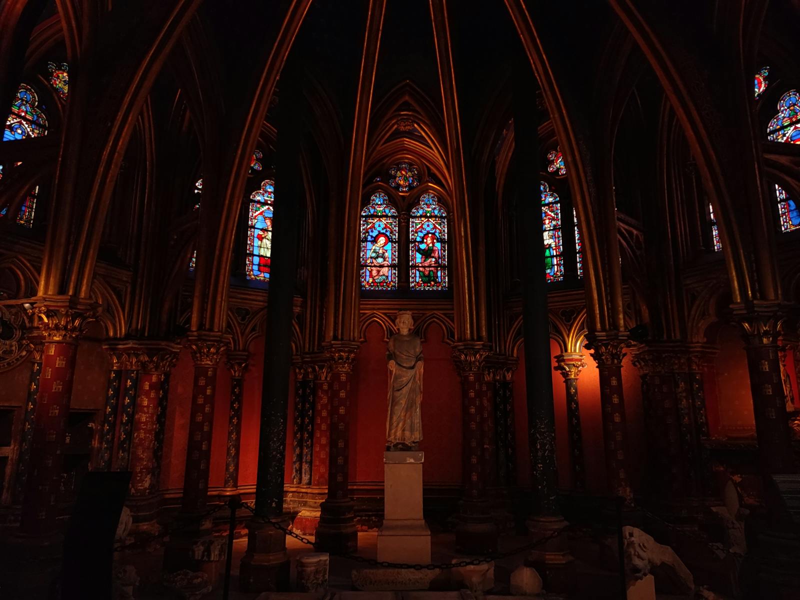 Gothic interior of Sainte-Chapelle in Paris with stained-glass windows and sculptures