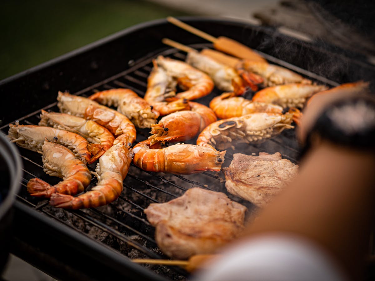 Grilled shrimp and seafood sizzling on a charcoal barbecue