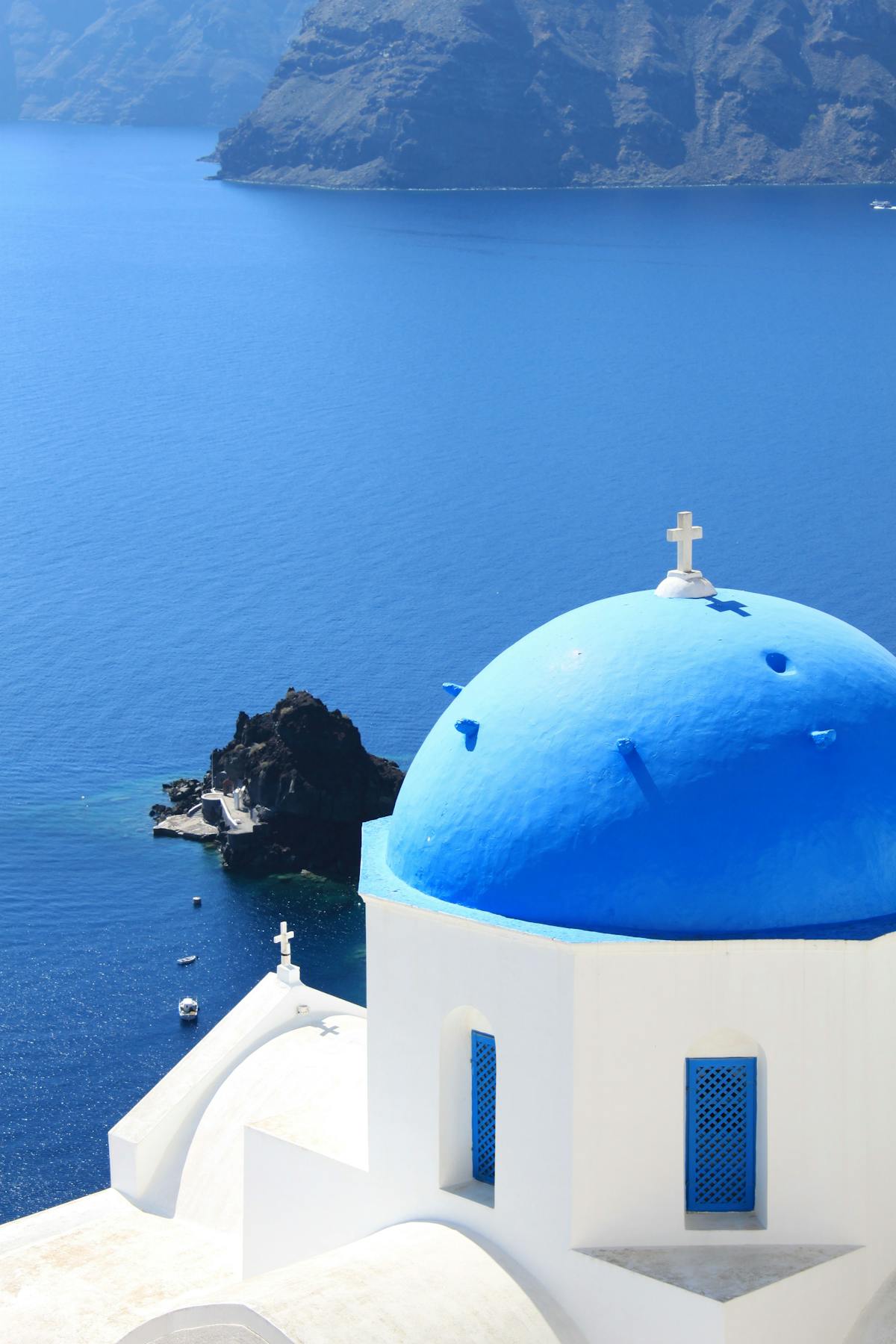 Santorini's blue dome church against the Aegean Sea