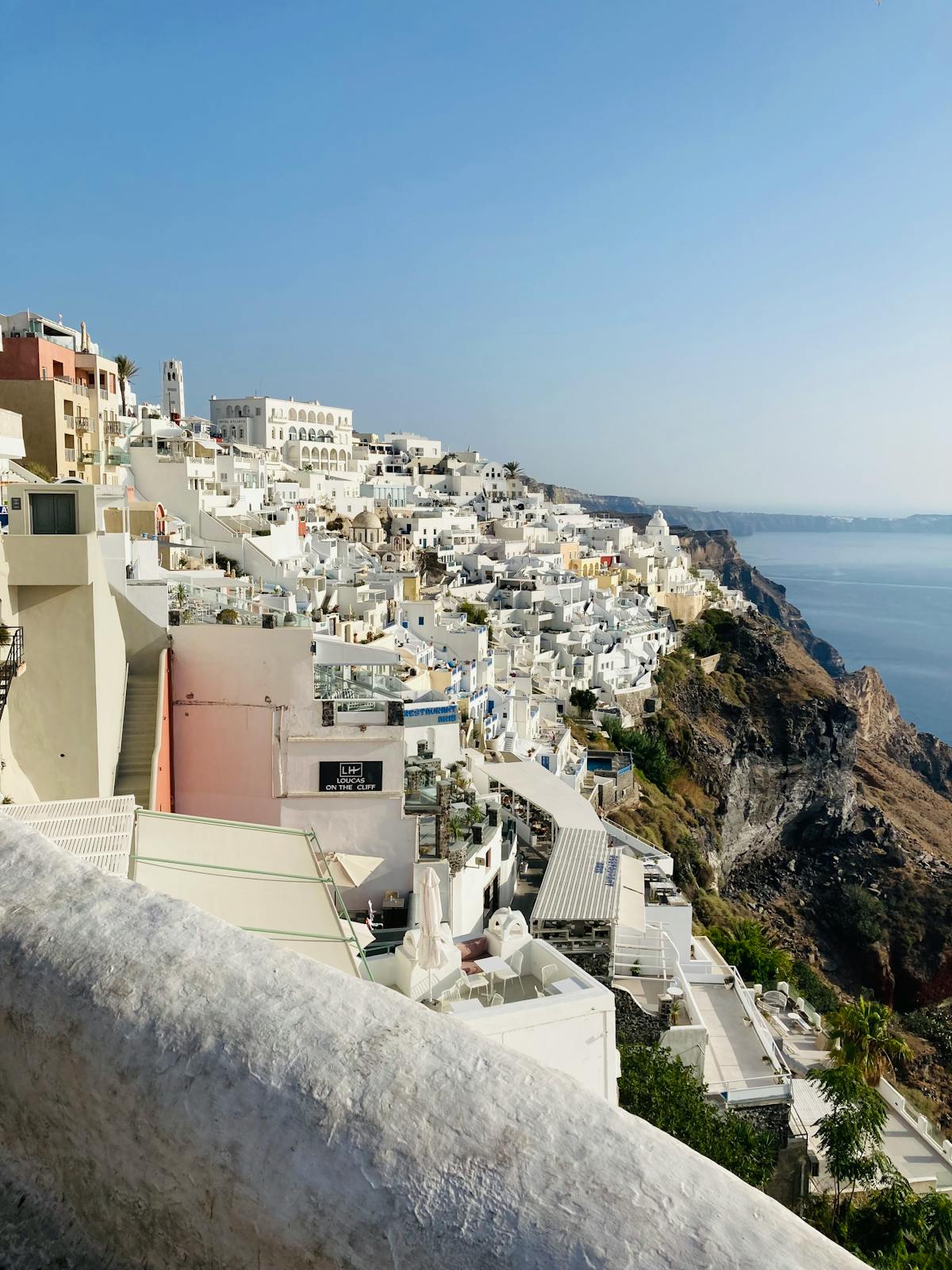 White buildings of Fira perched on Santorini's cliffs