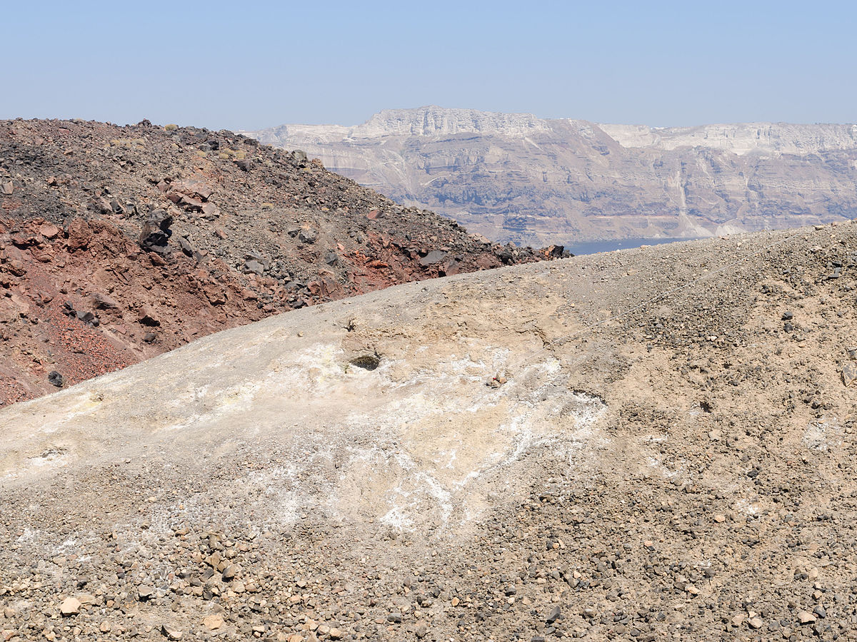 Nea Kameni volcanic island in Santorini with rugged terrain