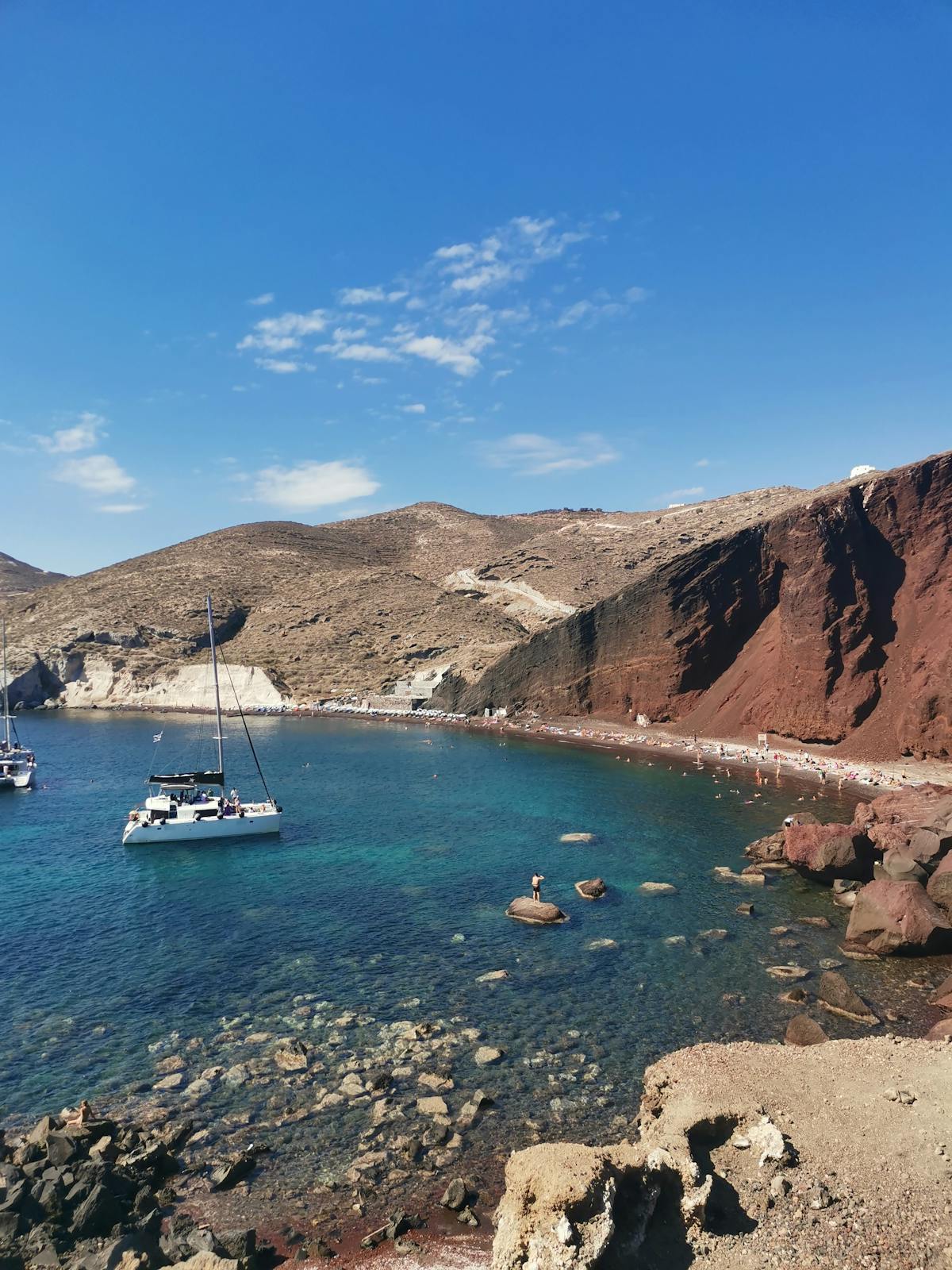Red Beach in Santorini with crystal waters and rocky coastline