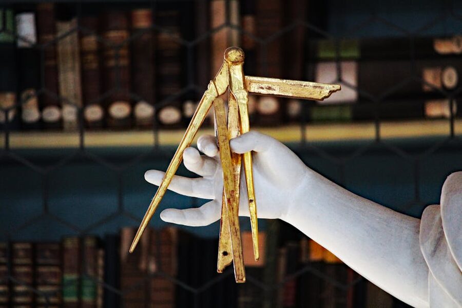 Sculpture holding golden calipers in library