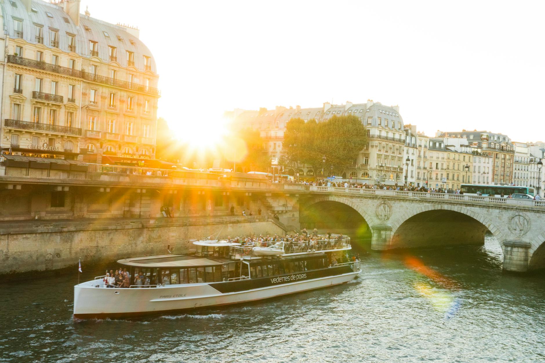 A Seine river cruise boat during sunset in Paris